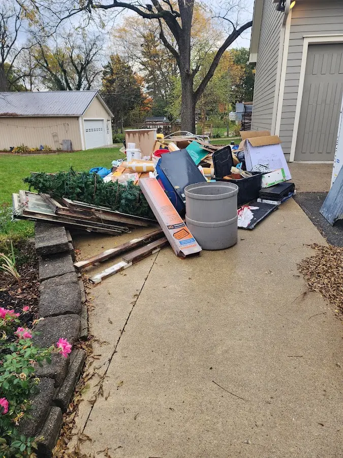 Dumpster being loaded with debris for Commercial Dumpster Rental in Carey